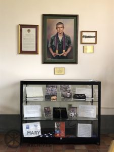 Fr. Vincent Capodanno MM's portrait and biography above the exhibit on Fr. Capodanno at the Maryknoll Society Center