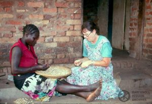 Lay Missioner Liz Mach preparing food with a refugee in Sudan