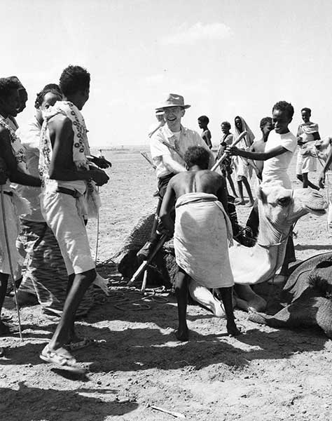 Fr. John P. Casey riding a camel in Tanzania