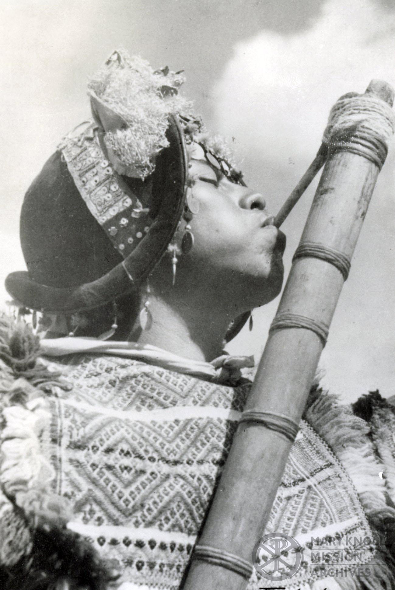 Woman with wind instrument, Bolivia