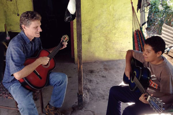 Former Lay Missioner Rick Dixon with Alex, playing guitar in La Esperanza