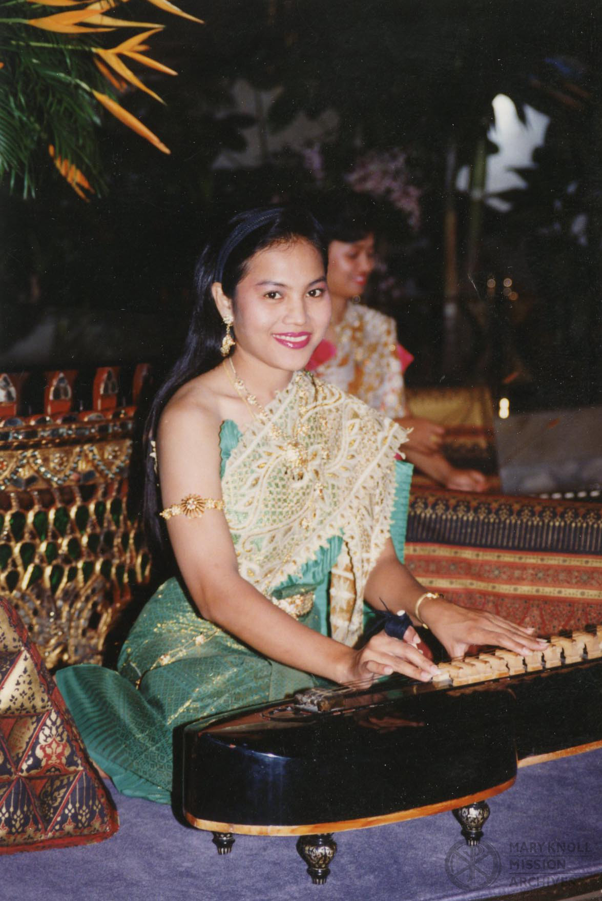 Woman with string instrument, Thailand