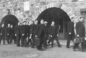 Departure, 1942 - Fr. John J. Lawler is in the center, carrying a suitcase