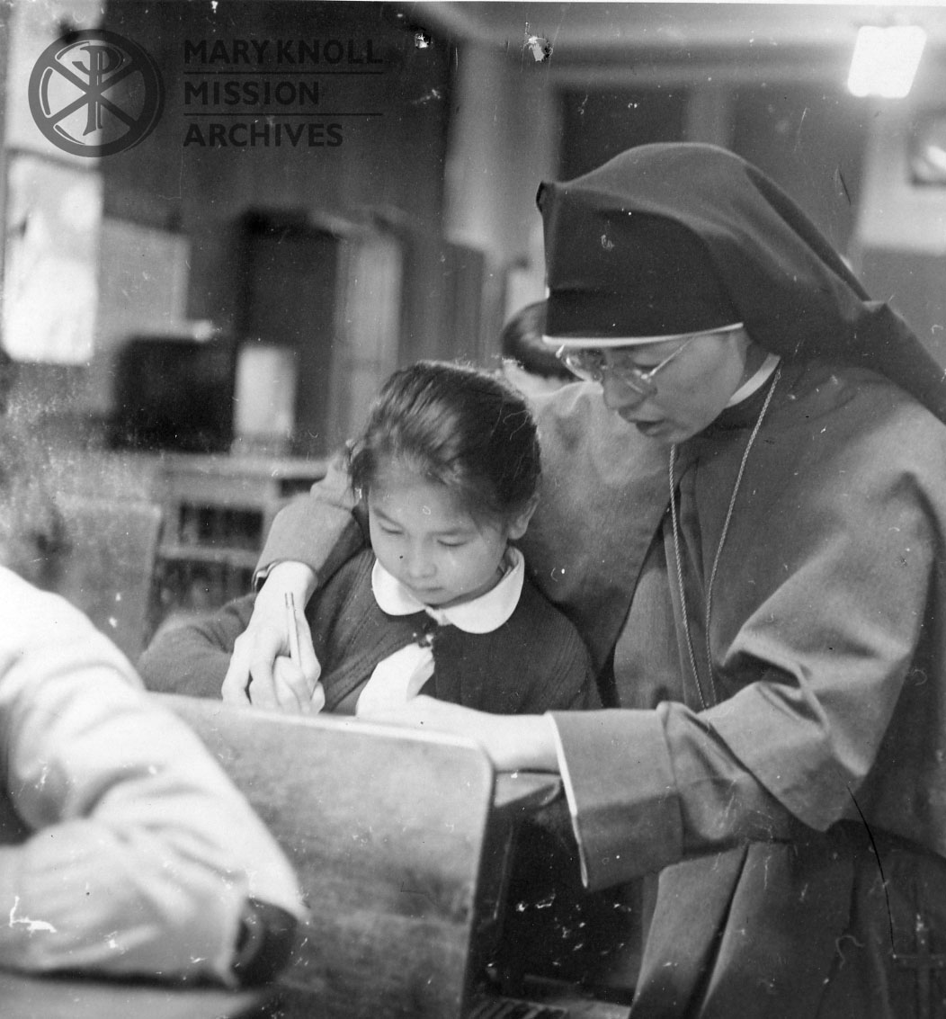 Lee_SrMarieClementia_Chicago_Chinatown_watermark Sr. Marie Clementia Lee working with a student in Chinatown, Chicago.